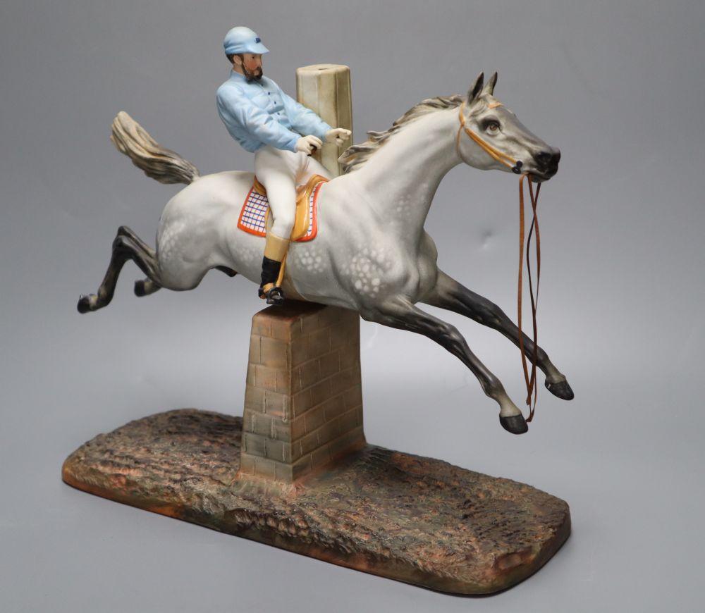 A cast coloured bisque porcelain horse and jockey group, height 26cm